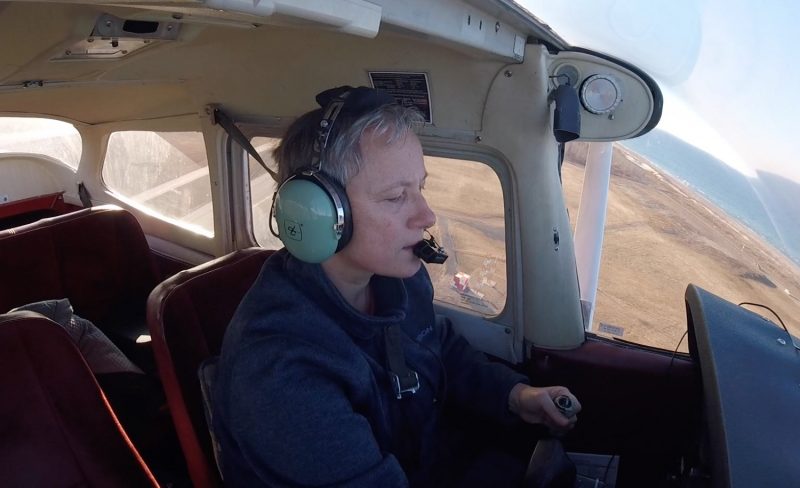 Photograph of Ombretta Debois flying a plane